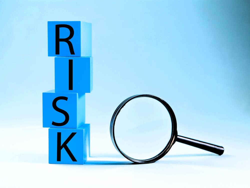 Risk blocks with magnifying glass, representing organized risk analysis